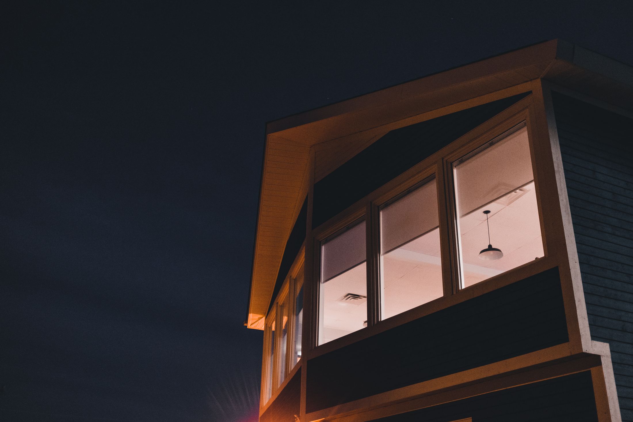 Glass-fronted contemporary house photographed at night